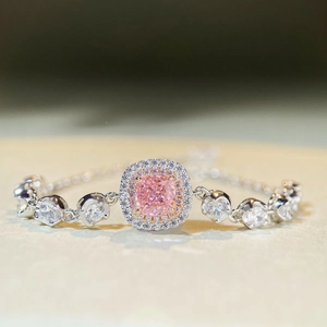 Macro detail of cushion cut pink stone bracelet with white zircon pavé settings