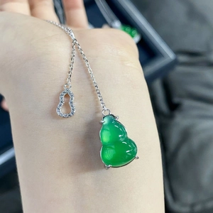 Detail of green chalcedony gourd pendant with silver chain and pavé diamond accent