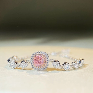 Macro shot of S925 silver bracelet with pink cushion cut stone and double halo setting