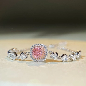 Macro shot of cushion-cut pink gemstone bracelet with sparkling zircon double halo