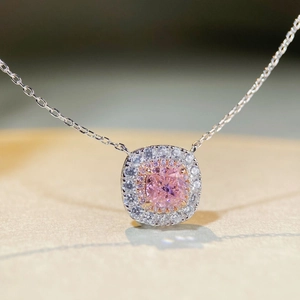 Macro shot of cushion cut pink diamond pendant with double halo stones and silver chain