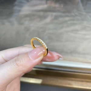Close-up of hand-held S925 sterling silver moissanite ring with 18K gold plating
