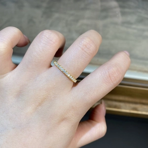 Close-up of S925 silver ring with small round moissanite stones in 18K gold finish