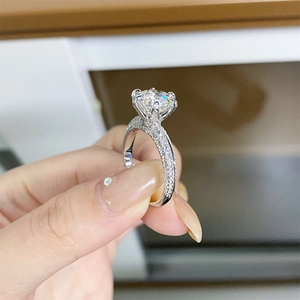 Round brilliant-cut moissanite engagement ring with 925 silver pave band and 6-claw setting