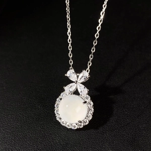 Detailed macro view of S925 sterling silver bow pendant with white chalcedony gemstone