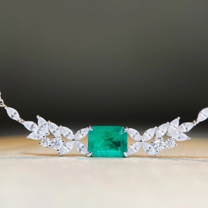 S925 sterling silver necklace with emerald cut green gemstone and leaf leaf diamond accents