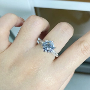 Macro shot of 925 silver moissanite ring showing brilliant fire and pavé diamond band