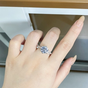 Detail view of 925 silver moissanite ring showing brilliant round cut main stone and side pavé