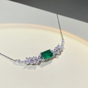 Macro shot of S925 sterling silver necklace with emerald cut stone and marquise diamonds