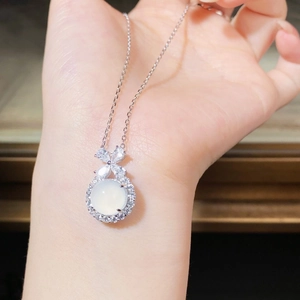 Macro view of S925 sterling silver bow pendant with white chalcedony gemstone