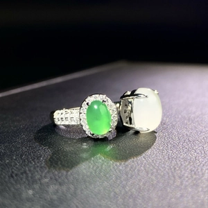 Detailed macro of two S925 silver rings with green chalcedony and white jade gemstones