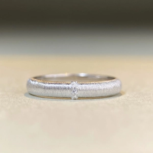Macro shot of 925 sterling silver brushed ring with three small inlaid crystals