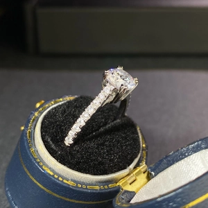Macro shot of 925 silver moissanite ring in vintage blue velvet jewelry gift box