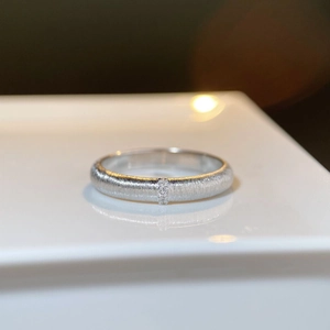 Detail of brushed 925 silver ring featuring three vertically set zircon stones