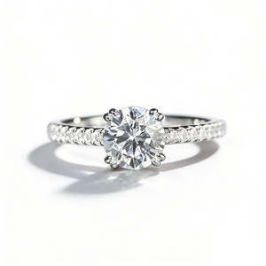 Classic S925 sterling silver four-prong moissanite ring with pavé stones on a white background