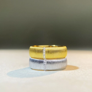 Detailed macro view of brushed 925 silver rings with vertical row of zircon stones
