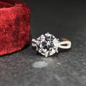 Macro shot of 5 carat moissanite ring with six-prong setting and pavé hollow band