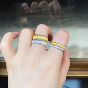 Detail of brushed 925 sterling silver rings with tiny zircon inlay on a hand