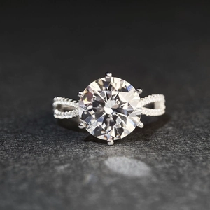 Macro shot of 5-carat moissanite ring with six-prong setting and pavé twisted band