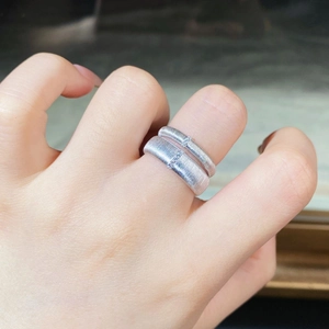 Close-up of 925 sterling silver brushed rings with small diamond inlay on hands
