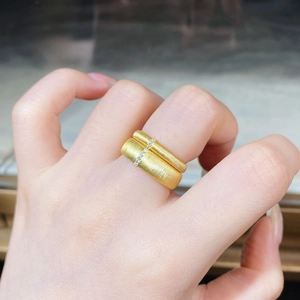 Close-up of stacked matte 18K gold plated rings with vertical diamond micro-pave setting