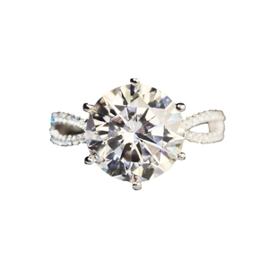 5-carat round moissanite ring with six-prong setting and twisted pavé diamond band