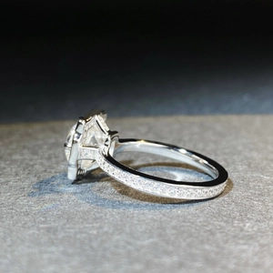Classic 925 sterling silver moissanite ring featuring a four-prong setting and pavé diamonds
