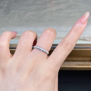 Detail of 925 sterling silver brushed ring with a tiny round-cut diamond accent