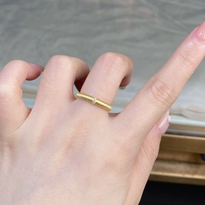 Close-up of 18K gold plated 925 silver ring with brushed finish and tiny gemstone