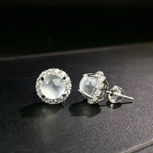 Macro detail of S925 silver chalcedony stud earrings with halo diamond setting