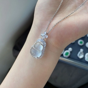 Detail eines Silber-Anhängers in Kürbisform mit Jade und Diamanten an einer Halskette