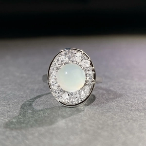 Elegant adjustable silver ring with oval translucent green chalcedony and diamond halo