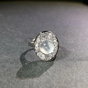 Macro side view of imperial green chalcedony ring with layered diamond halo setting