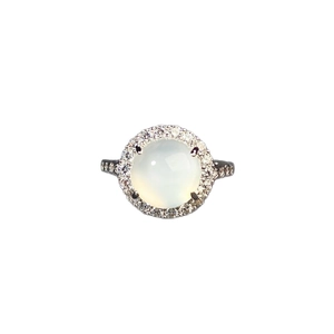 Adjustable silver ring featuring a round green chalcedony stone with halo diamond accents