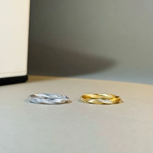 Detail of Mobius rings with brushed silver finish and delicate pave-set diamonds