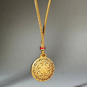 Exquisite gold filigree hollow pendant necklace with red bead on adjustable woven cord