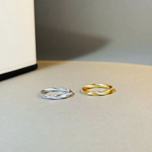 Detail of S925 silver Mobius rings with brushed texture and sparkling zircon stones