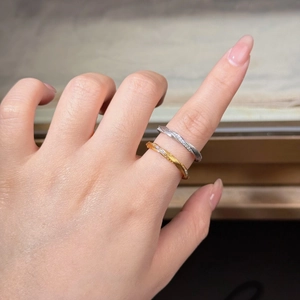 Close-up of S925 sterling silver Mobius rings with twisted rope texture and pavé stones