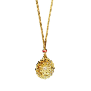 Vintage gold lotus pendant necklace with intricate filigree and red accents on white background