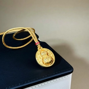 Golden rotating gourd pendant necklace with traditional hollow carved design for unisex