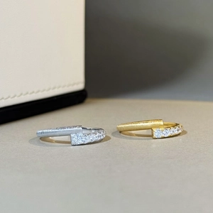 Macro shot of 925 silver rings featuring brushed metal texture and fine zircon inlay detail