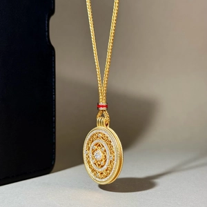 Golden sand-gold compass pendant necklace with filigree detail and red enamel