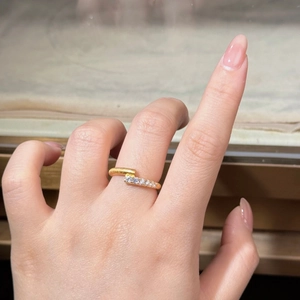 Close-up of 18K gold-plated sterling silver ring featuring a unique asymmetric five-stone design