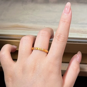 Macro shot of silver bamboo ring with brushed texture and inlaid diamonds on finger