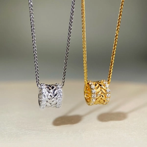 Detail of silver and gold wheat ear cylinder pendants with sparkling pavé zircons