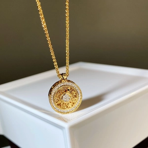 Ancient gold compass pendant necklace with hollow pattern and sparkling zircon inlay