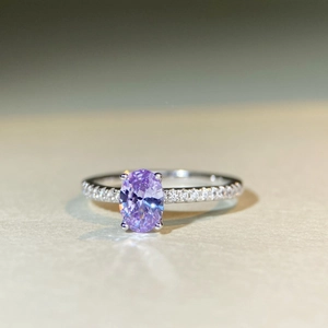 Macro detail of oval lavender gemstone on S925 silver ring with pavé-set diamond band