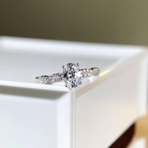 Oval-cut 1 carat moissanite ring in 925 sterling silver with micro-pave twisted band