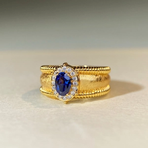 Gold plated ring with oval blue sapphire and brushed matte finish for women