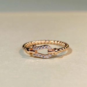 Macro shot of 18K rose gold plated 925 silver horseshoe ring with pavé cubic zirconia